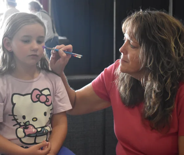 Artist paints picture of fair face-painting tradition